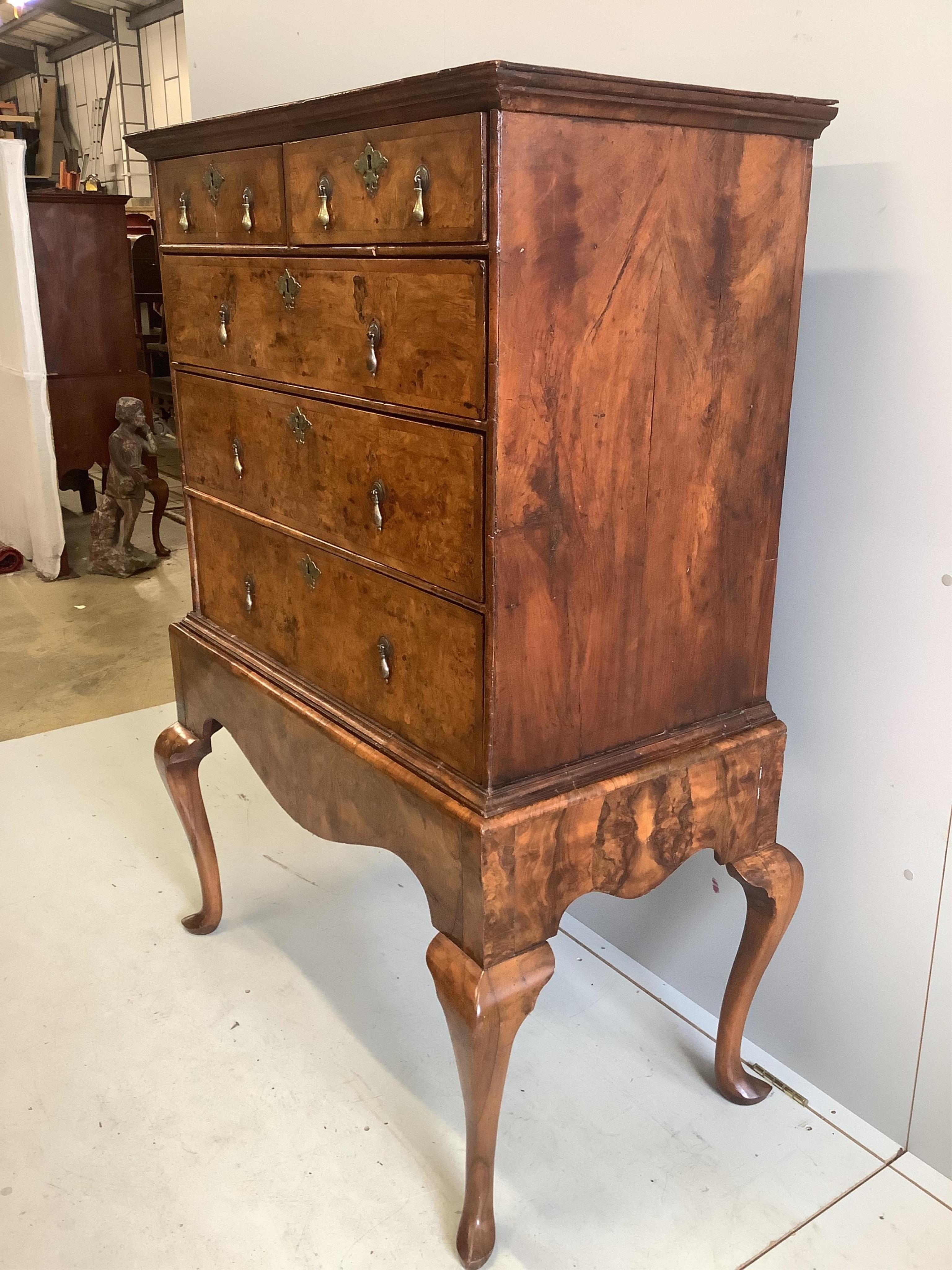 An early 18th century walnut chest on stand, width 98cm, depth 53cm, height 148cm. Condition - fair to good